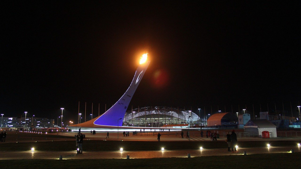 The Olympic flame will shine in front of a smaller crowd, as fan capacity for the Olympics will be reduced.